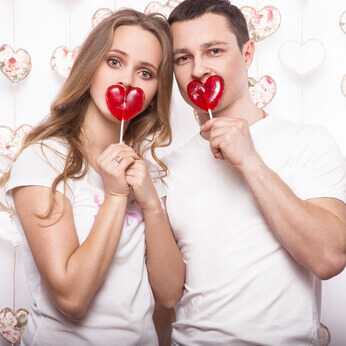 young, beautiful woman and man in love on Valentines Day with candy, Laughing Happy Lovers, showing different poses
