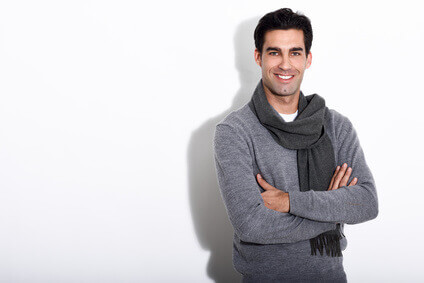 Handsome man wearing winter clothes on white background